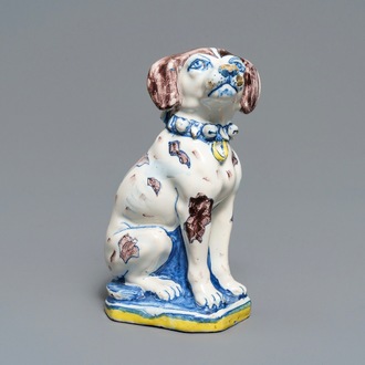 A polychrome Dutch Delft model of a dog, early 18th C.