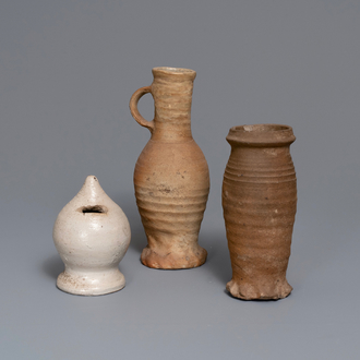 Two early German stoneware jugs and a money bank, 14/15th C. and later