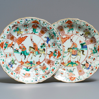 A pair of Chinese famille verte lotus-moulded 'Mu Guiying' plates, Kangxi