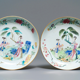 A pair of Chinese famille rose plates with ladies in a garden, Yongzheng/Qianlong