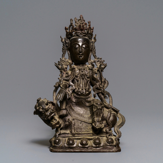A Chinese bronze figure of Guanyin on a qilin, Ming