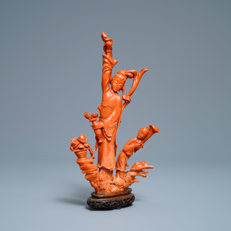 A Chinese carved red coral group of a lady and child, 19th C.