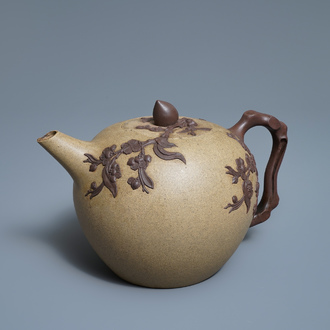 A large Chinese Yixing stoneware teapot with applied prunus design, Kangxi