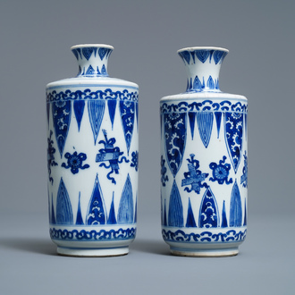 A pair of Chinese blue and white 'Buddhist emblems' rouleau vases, Kangxi