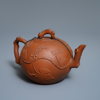 A large Chinese Yixing stoneware teapot with applied grape vines design, Kangxi