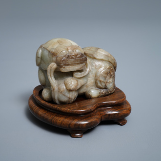 A Chinese pale grey-brown jade model of a Buddhist lion, 19/20th C.