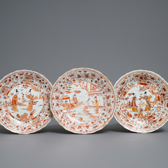 Three Chinese iron red and gilt lotus-moulded plates, Kangxi