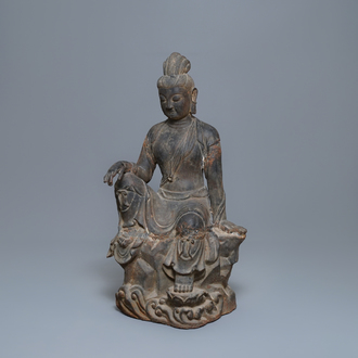 A large Chinese cast iron figure of Guanyin with inscription on the back, Ming/Qing