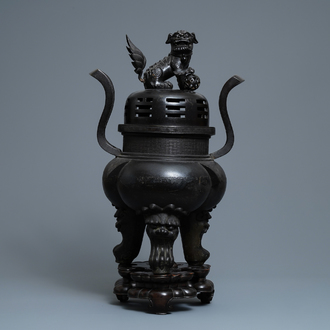 A large Chinese bronze incense burner and cover on carved wooden stand, Ming