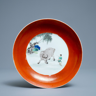 A Chinese famille verte coral-ground 'buffalo shepherd' plate, Yongzheng mark and of the period