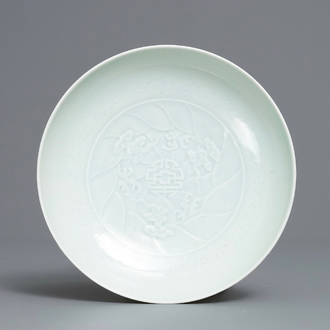 A Chinese celadon saucer dish with underglaze design, Yongzheng mark and poss. of the period