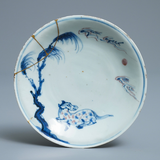 A Chinese blue, white and underglaze red plate with a horse and kintsugi repair, Tianqi