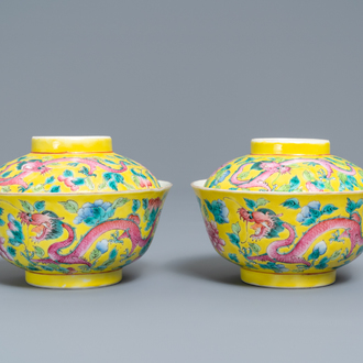 A pair of Chinese yellow-ground famille rose 'dragon and phoenix' bowls and covers, 19th C.