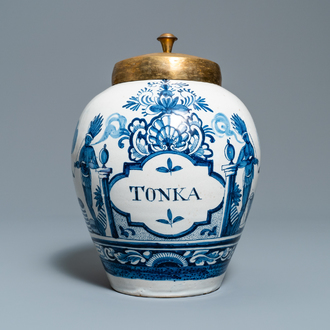 A Dutch Delft blue and white tobacco jar with American Indians and inscribed 'Tonka', 18th C.