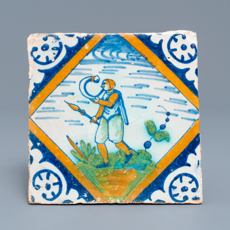 Un carreau en majolique polychrome à décor d'un souffleur de corne, Delft, vers 1600