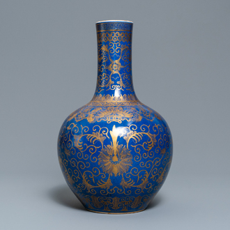 A Chinese powder blue and gilt 'lotus scroll' bottle vase, Kangxi mark, 19/20th C.