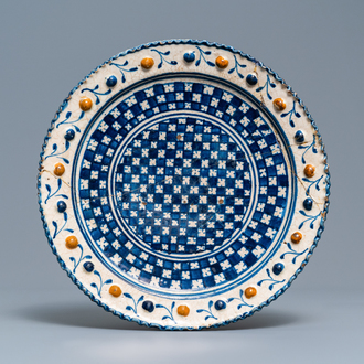 Un plat en majolique polychrome à décor géométrique dit 'au damier', Pays-Bas, 1er quart du 17ème
