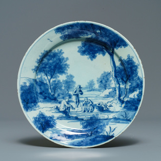 A fine Dutch Delft blue and white plate with figures in a landscape, 1st quarter 18th C.