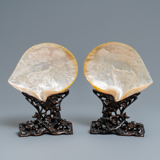 A pair of Chinese carved mother-of-pearl shells on wooden stands, 19th C.