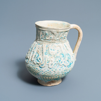A Persian turquoise-glazed moulded calligraphic ewer, Kashan, 13/14th C.