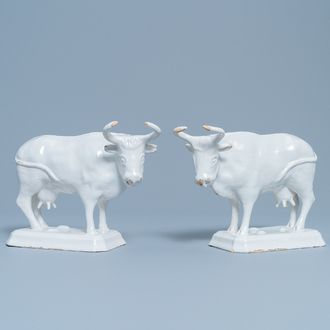 A pair of white Dutch Delftware cows on bases, 18th C.