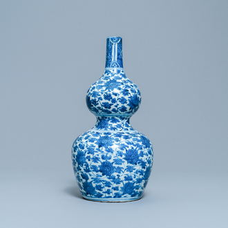 A Chinese blue and white 'lotus scroll' double gourd vase, Wanli