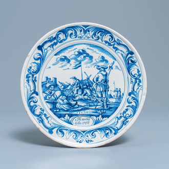 A Dutch Delftware blue and white dish with soldiers at camp, Makkum, dated 1764