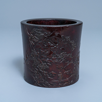 A Chinese carved zitan wood brush pot with a mountainous landscape, 17/18th C.