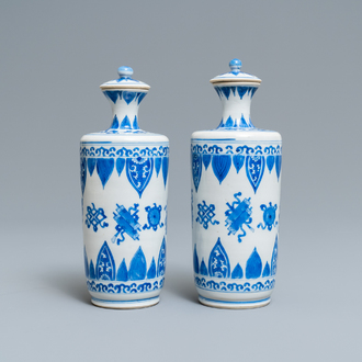 A pair of Chinese blue and white vases and covers, Kangxi