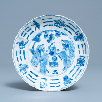 A Chinese blue and white plate with scholars admiring a scroll, Chenghua mark, Kangxi