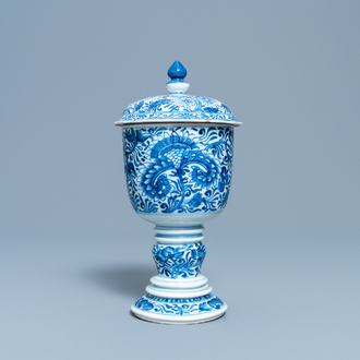 A Chinese blue and white beaker and cover with floral design, Kangxi