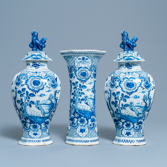 A Dutch Delft blue and white three-piece vase garniture with a dog, 18th C.