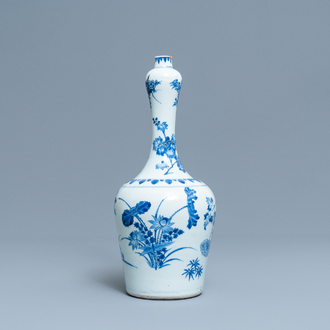 A Chinese blue and white bottle vase with floral design, Transitional period