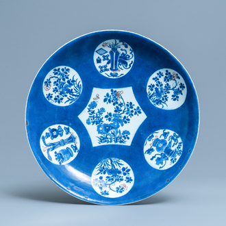 A Chinese blue, white and copper red powder blue-ground charger, Kangxi