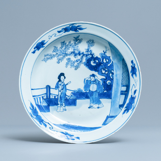 A Chinese blue and white dish with two figures in a garden, Transitional period