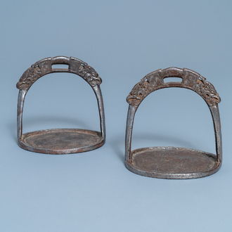 A pair of Tibetan iron stirrups with dragons, 17th C.