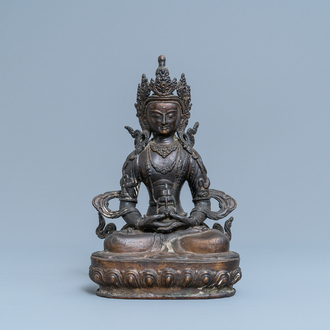 A Sino-Tibetan gilt bronze figure of Buddha, 19th C.