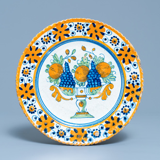 A polychrome Dutch maiolica dish with a fruit tazza, 1st half 17th C.