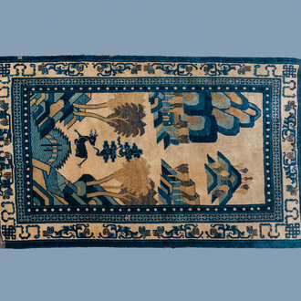 A rectangular Chinese Beijing silk carpet with a deer in a landscape, 19th C.