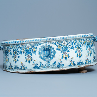 A large oval polychrome French faience armorial basin, Rouen or Paris, 18th C.