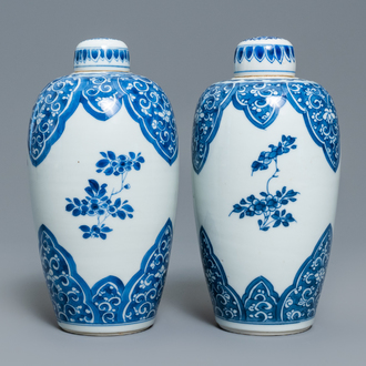 A pair of Chinese blue and white lidded jars with floral design, Kangxi