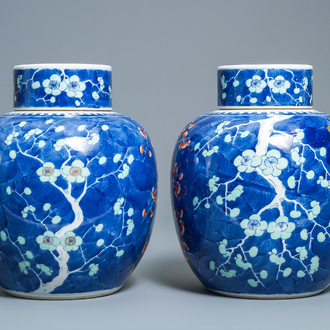 A pair of Chinese polychrome 'prunus on cracked ice' jars and covers, 19th C.