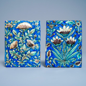 Two polychrome floral relief-moulded tiles, Qajar, Iran, 19th C.