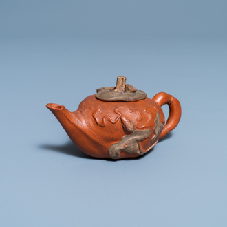 A Chinese relief-decorated Yixing stoneware teapot and cover, 18/19th C.