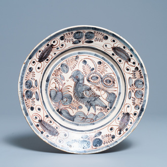 A blue, white and manganese Portuguese faience charger with a bird, 17th C.