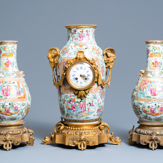 A Chinese gilt bronze-mounted three-piece Canton famille rose clock garniture, 19th C.