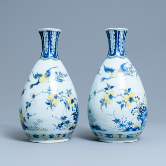 A pair of unusual polychrome Dutch Delft chinoiserie vases with a dragon and birds in a flowery garden, 17th C.