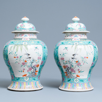 A pair of Chinese famille rose vases and covers, 19th C.