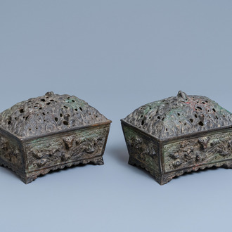 A pair of Chinese Ming-style bronze censers with reticulated covers, 19th C.