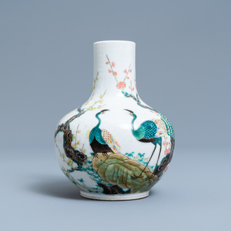 A Chinese famille rose bottle vase with peacocks, Qianlong mark, 19th C.